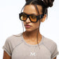 Woman wearing futuristic sunglasses with a white background