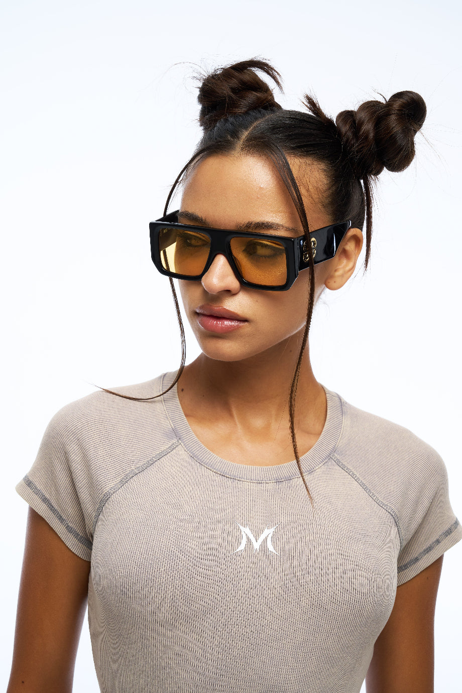 Woman wearing futuristic sunglasses with a white background