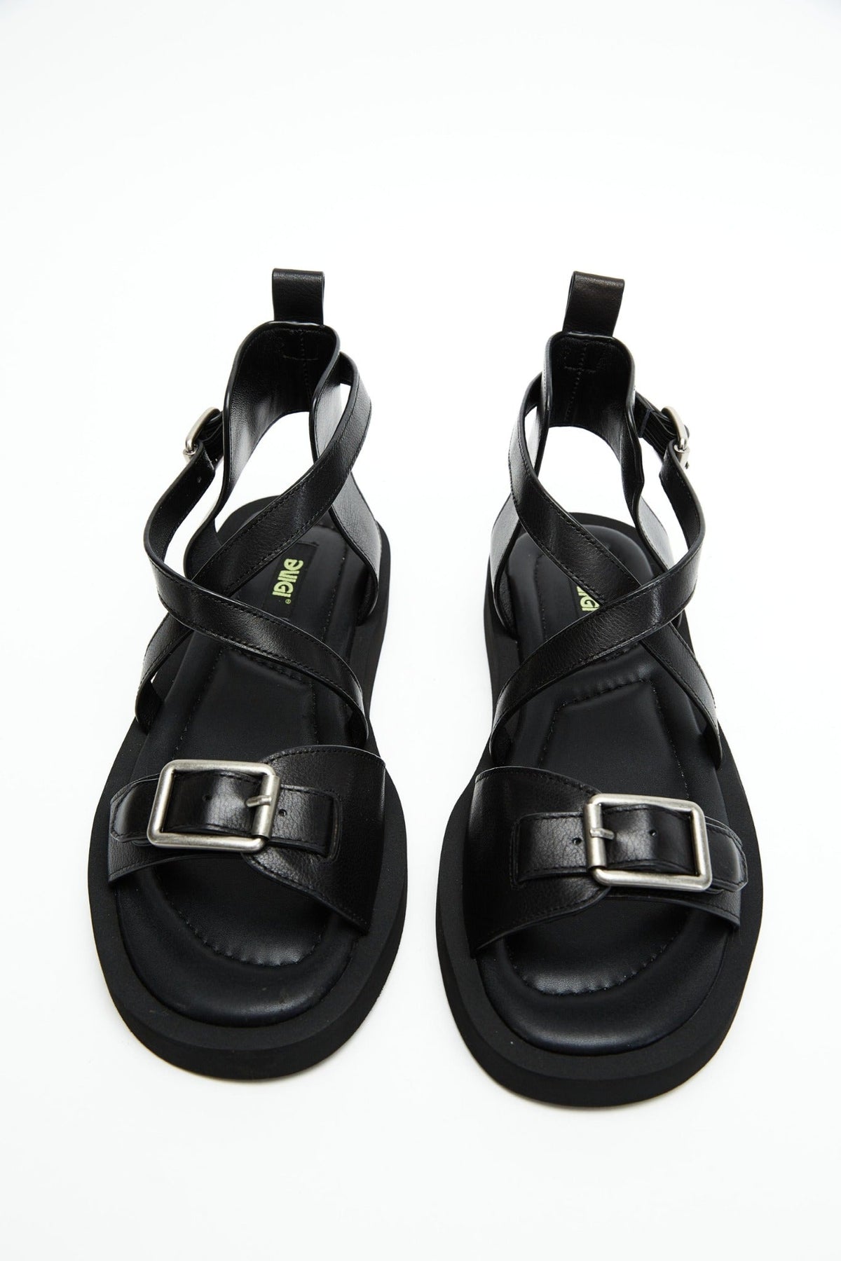 Top view of black genuine leather sandals with crossover straps and antique-silver buckles