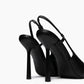 Rear view of black leather slingback heels showing slim straps and high flared stilettos