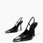 Angled pair of black pointed slingback heels with silver-tone metal toe caps