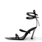 Black leather wraparound heel with mirrored pointed toe cap and sculptural high heel, side profile