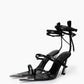 Pair of black strappy leather heels with mirrored pointed toes and wraparound ankle straps