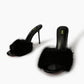 Black natural fur mule heels, front three-quarter view
