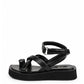 Black leather toe-loop platform sandal with padded crossover straps and ankle wrap, side profile