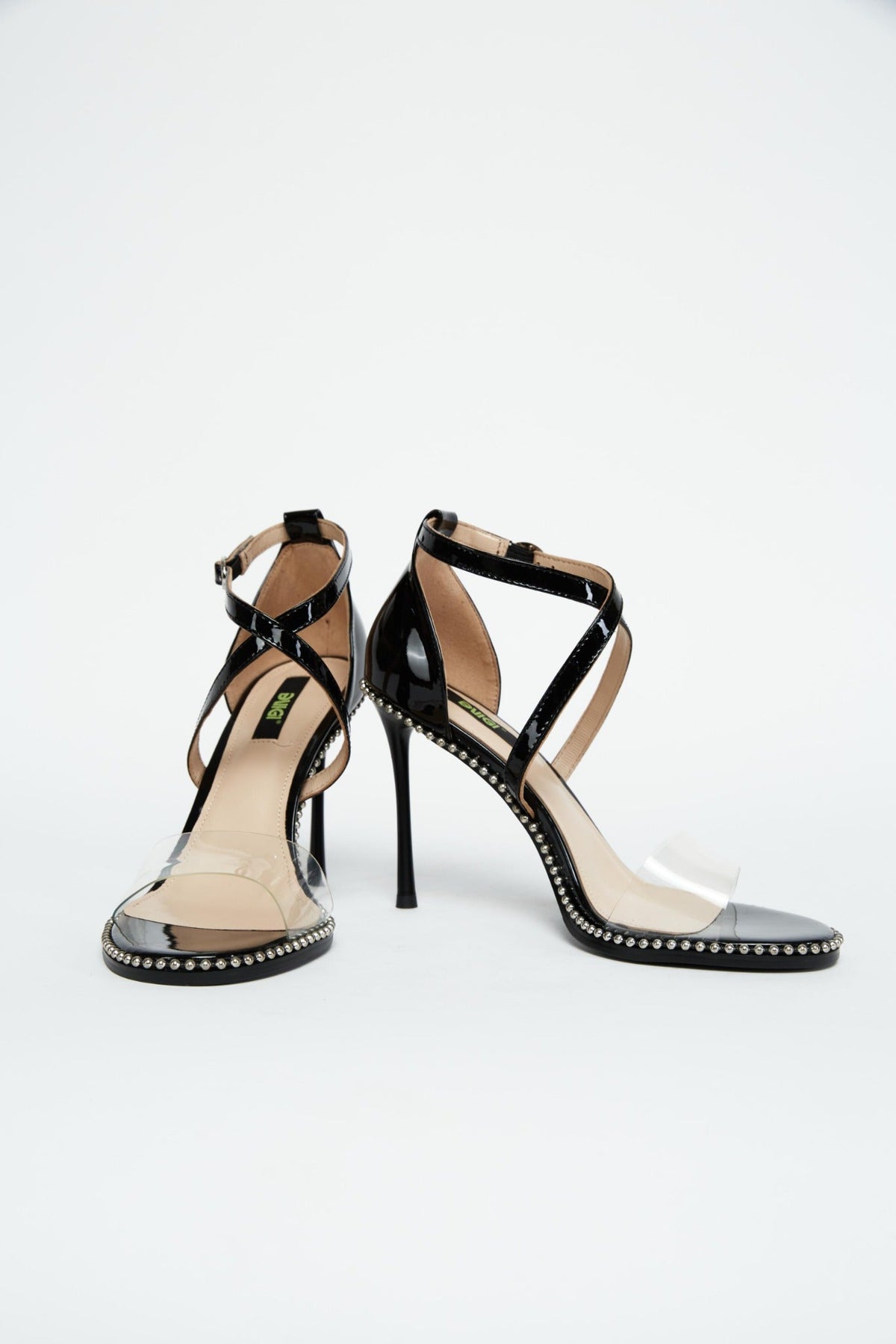 Front and side views of black patent stiletto heels with silver trim