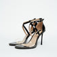 Pair of black patent heels with clear PVC toe straps and crossed ankle straps