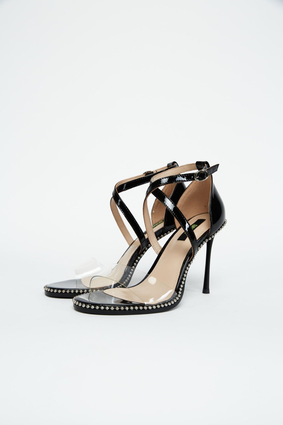 Pair of black patent heels with clear PVC toe straps and crossed ankle straps