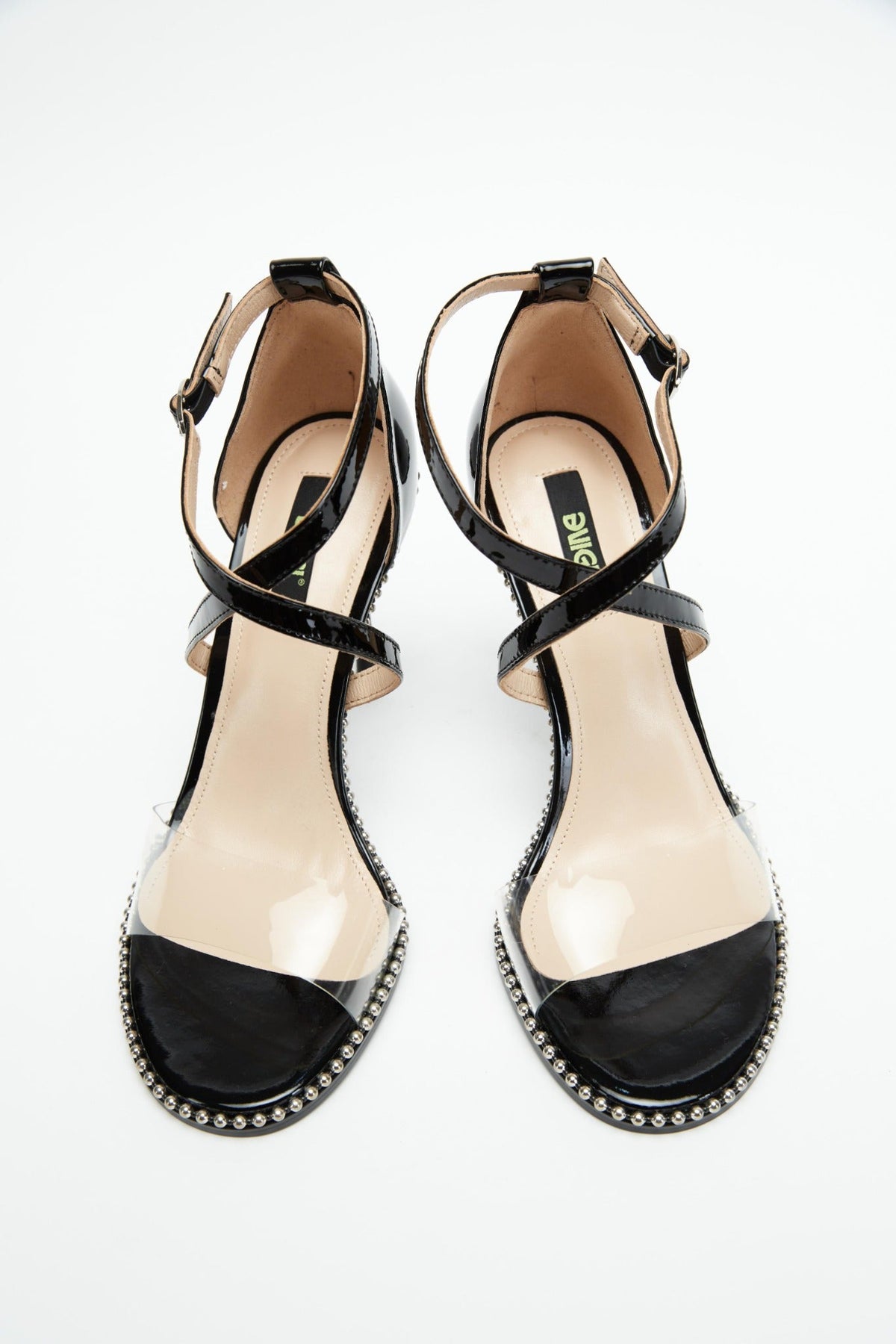 Top view of black patent heels with transparent front straps
