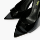 Black patent leather mules with open toe and pointed footbed detail