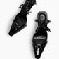 Black EVIGI patent leather spiked heels — top view