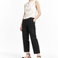 Black rosette sandals styled in a restrained white studio look