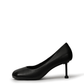 Black square-toe pumps with a sculptural slim heel — side view