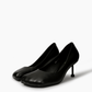 Pair of black square-toe pumps — three-quarter view