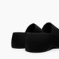 Rear view of black textile platform slides showing the sculpted sole profile