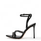 Black leather studded cross-strap heels with slim stiletto heel, side profile
