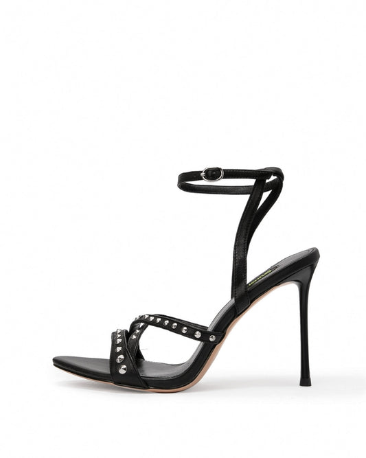 Black leather studded cross-strap heels with slim stiletto heel, side profile