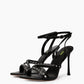 Pair of black leather heels with silver-tone studded cross straps and ankle buckles