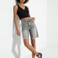 Full model styling black buckle ballet flats with grey denim and a cropped black top