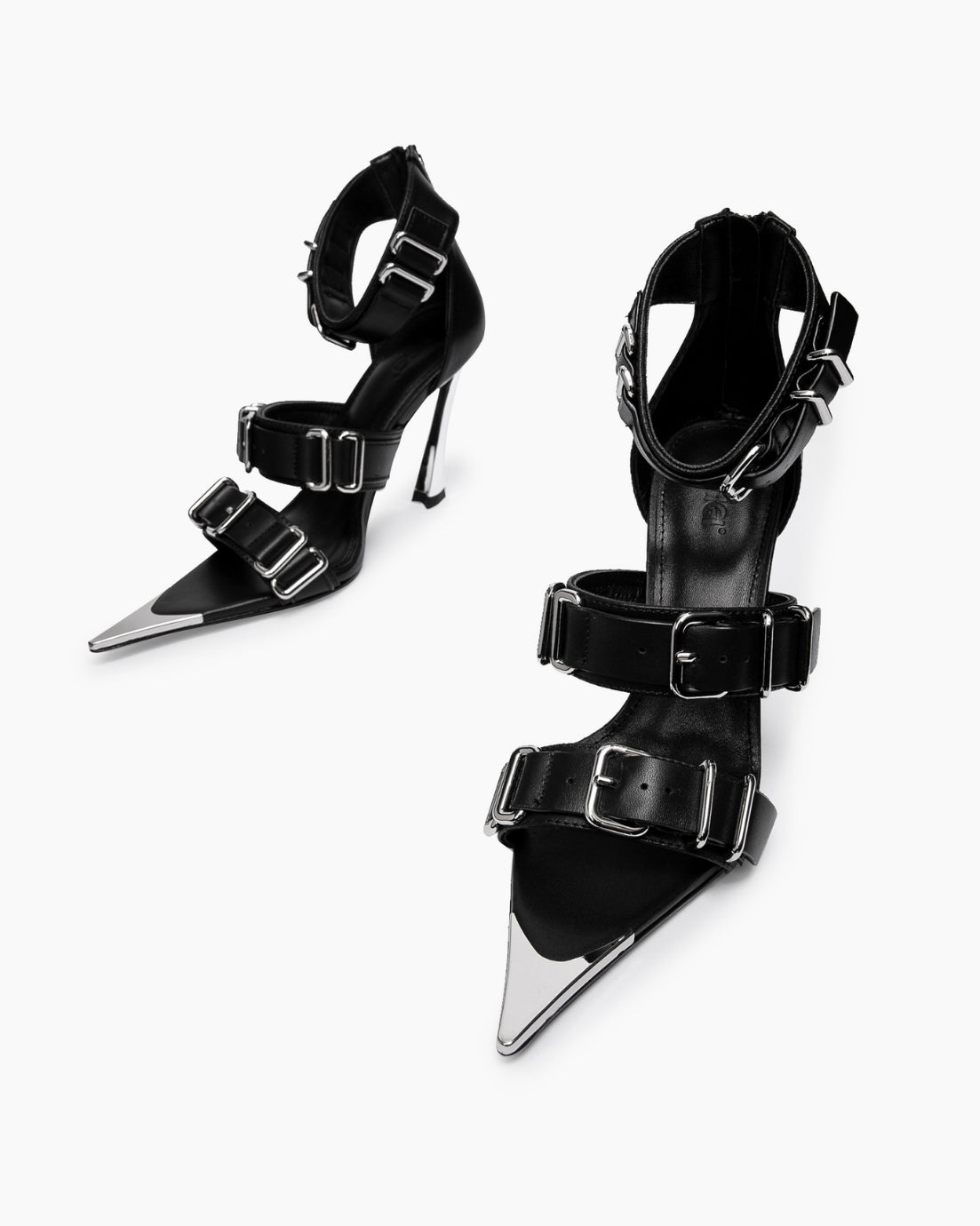 Top view of black leather buckle heels with chrome-coated pointed toe details
