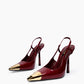 Pair of burgundy patent slingback heels with polished gold-tone pointed toe caps