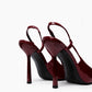 Rear view of burgundy patent slingback heels with narrow high stiletto heels