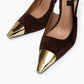 Close-up of velvety brown suede and sculpted gold pointed toe caps