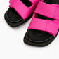 Close-up of fuchsia pink padded leather straps and cushioned black footbed