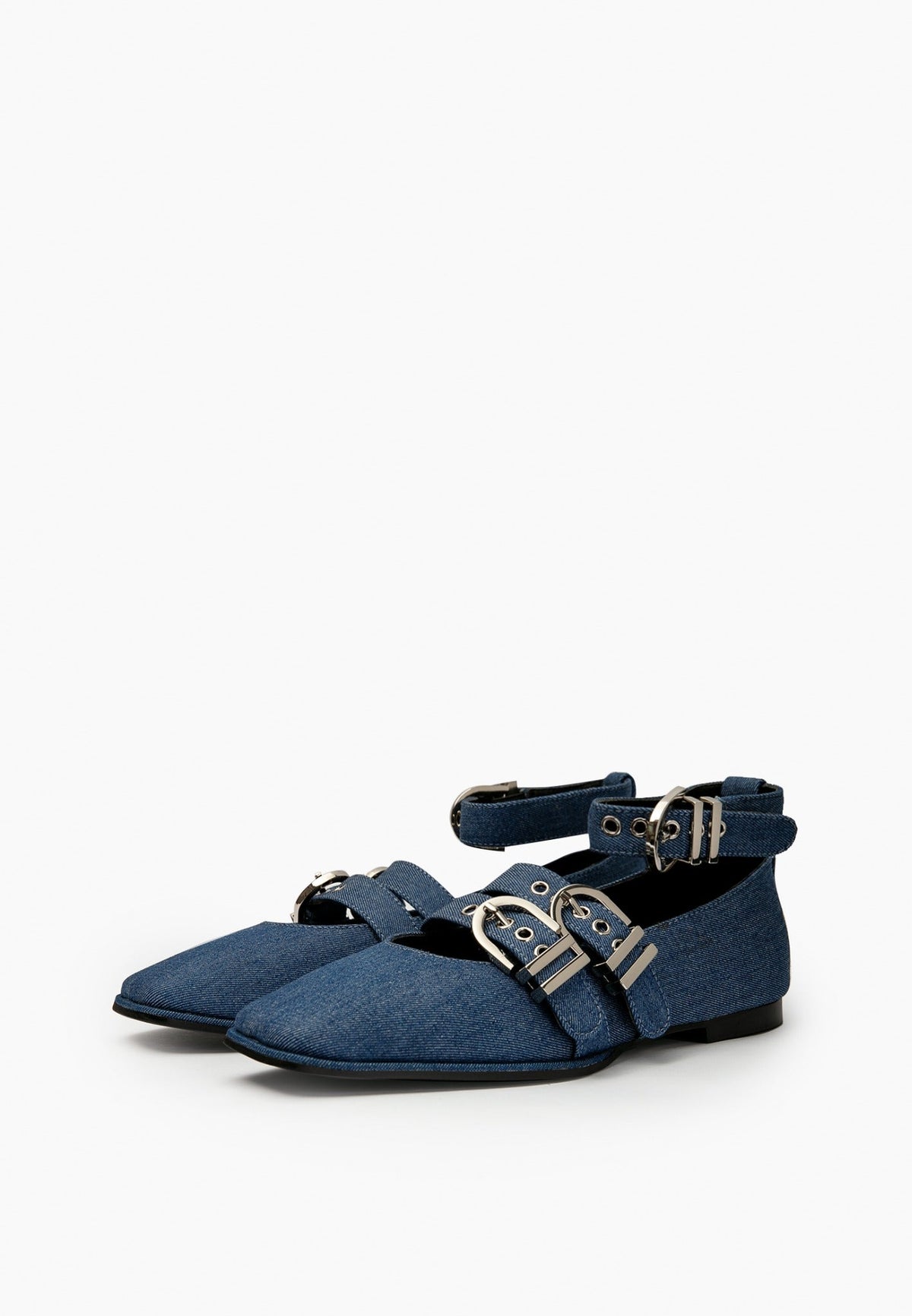 Pair of indigo denim ballet flats with square toes and silver-tone buckle straps