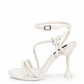 Ivory leather knot-strap heels with a sculpted flared heel, side view