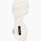 Top view of ivory leather heels with tubular straps and silver buckle