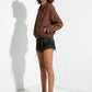 Leopard-print silicone strap heels in a full-length model look