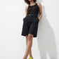 Woman styling lime green padded leather sandals with a black outfit