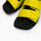 Close-up of lime green padded leather straps and black cushioned footbed