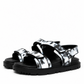 Pair of monochrome printed leather sandals with black lug soles, three-quarter view