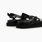 Rear detail of black leather sandal with adjustable silver-tone buckle