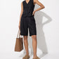 Taupe suede slip-on clogs styled in a monochrome studio look